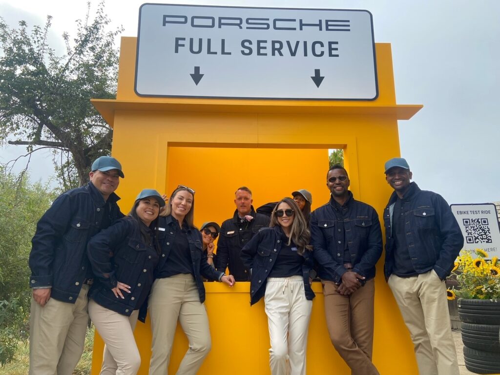 Porsche product specialist in front of display at Pebble Beach Concours d'Elegance