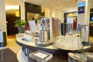 Nespresso coffee machine on table with accessories.