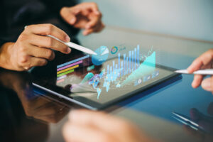 Person with a stylus hovering over a tablet with 3D graphics