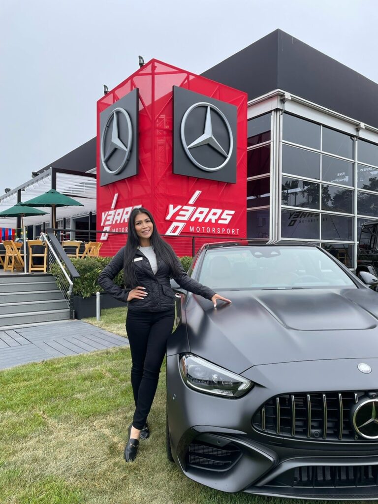 Mercedes-Benz product specialist in front of display at Pebble Beach Concours d'Elegance
