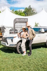 Two Lexus Product Specialists standing in front of vehicle at event.